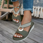 Green flat sandals with wide strap and round metal buckle