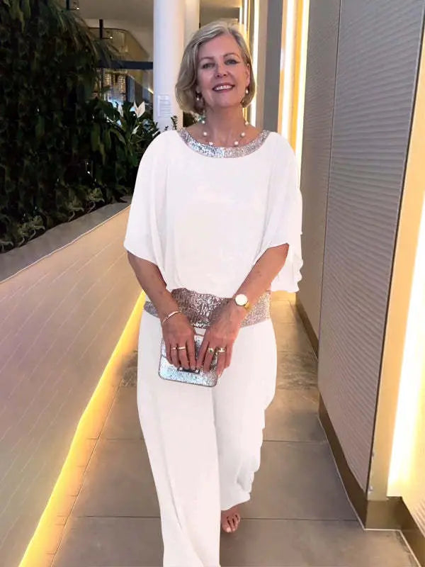 White 2-piece set with draped chiffon top, wide-leg pants, and silver sequin belt