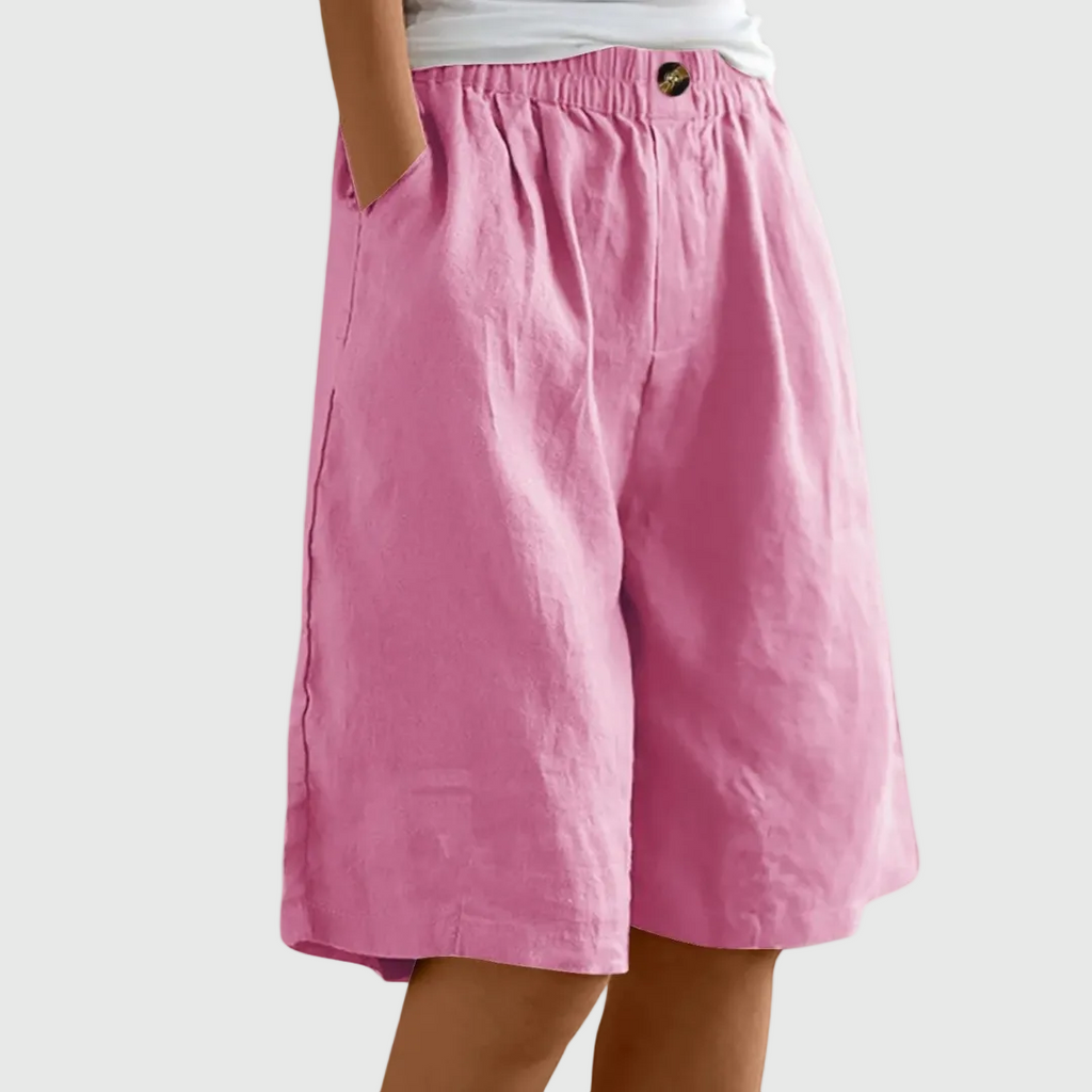 Loose fit elastic waist shorts in pink, with front seam and button detail at waistband