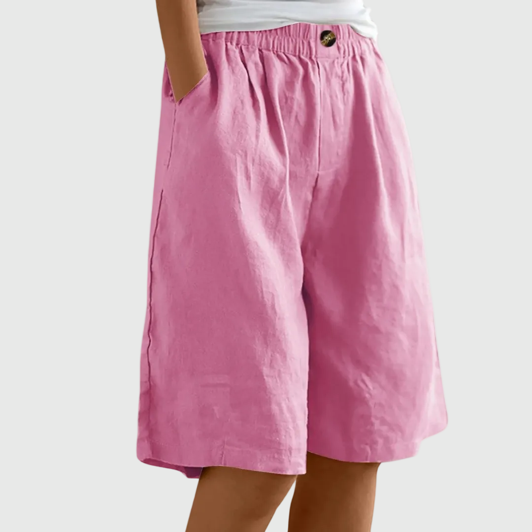 Loose fit elastic waist shorts in pink, with front seam and button detail at waistband