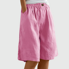 Loose fit elastic waist shorts in pink, with front seam and button detail at waistband