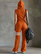 Orange hooded back view jumpsuit with striped cuff bands and lace shoulder trim