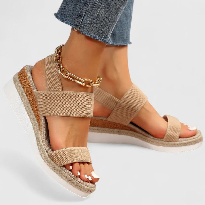 Beige orthopedic sandals with wide straps, espadrille sole, and gold chain ankle strap
