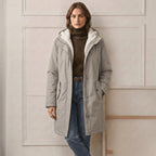 Light grey waterproof long parka with sherpa-lined hood and front zip pockets
