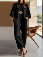Cotton stretchy loose jumpsuit, black, short sleeves, wide-leg, gold oval detail
