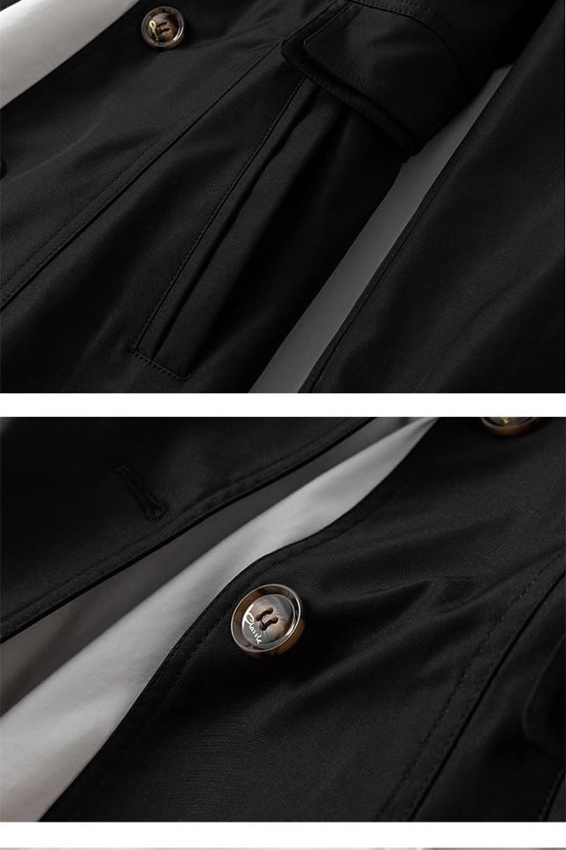 Black trench coat close-up with stitched seams and round metal button