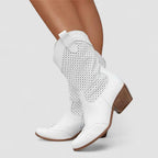 White orthopedic western boots with perforated panels and stacked heel