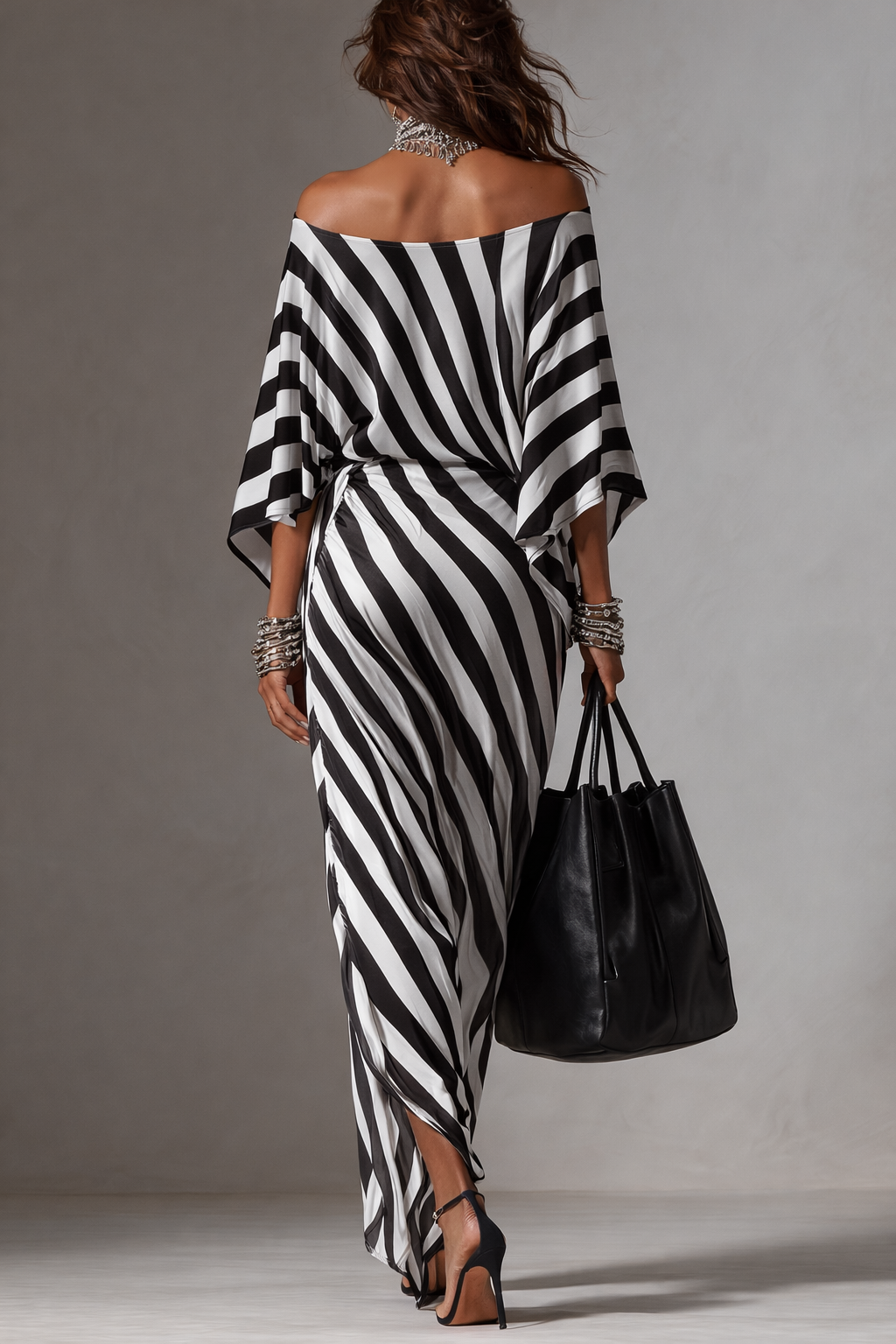 Black-and-white striped maxi dress with off-shoulder back, sash-like wrap and asymmetric hem