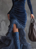 Dark blue velvet maxi dress with long sleeves, ruched stripes, and tiered ruffle hem