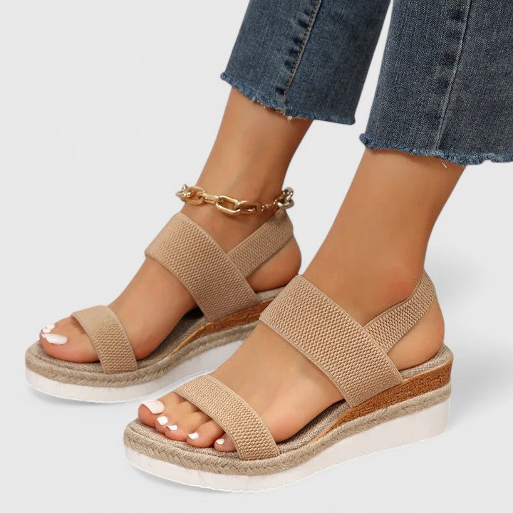 Beige orthopedic sandals with wide straps and tan espadrille sole, with gold chain ankle strap