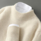 Cream cashmere mock-neck jumper close-up: ribbed collar, knit sleeve cuff.