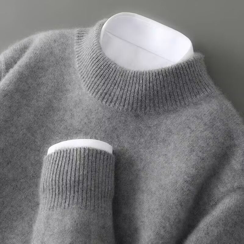 Dark grey cashmere mock-neck jumper with ribbed collar, cuffs, and hem.