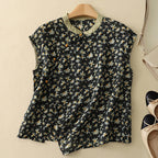 Black short-sleeve linen top with small daisy floral print and short button placket