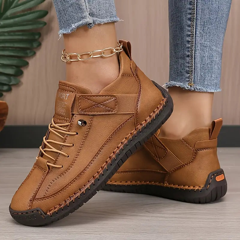 Brown comfort support sneaker with lace-up, ankle chain, and cushioned ankle collar