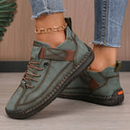 Green comfort support sneaker with lace-up, ankle chain, and padded heel strap