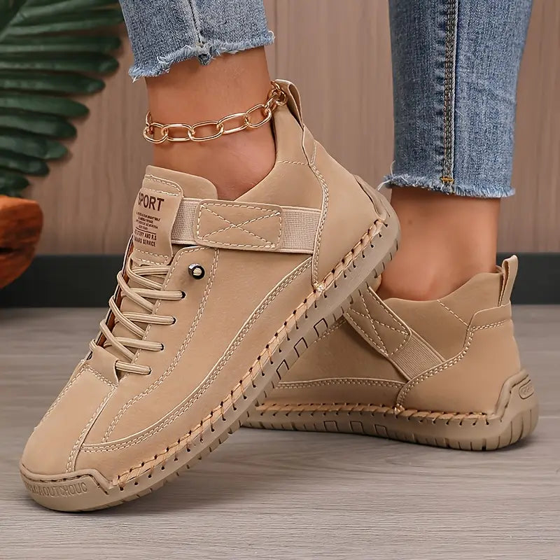 Beige comfort support sneaker with lace-up, ankle chain, and boot-style ankle support