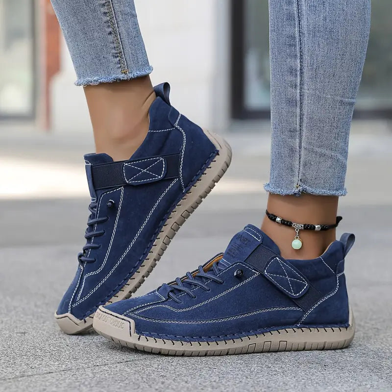 Dark blue comfort support sneaker with lace-up, ankle chain, and grippy rubber sole