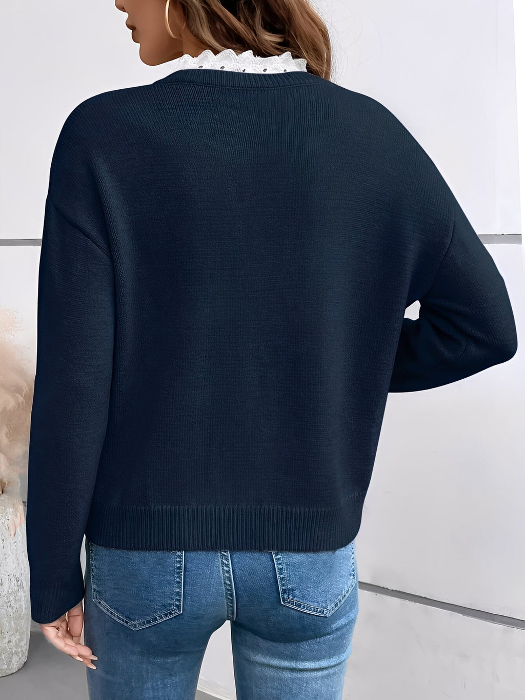 Kaitlyssa navy sweater, back view, with ribbed cuffs and V-neck lace trim
