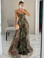 Maxi A-line V-neck dress with green painted floral print, spaghetti straps and waist tie