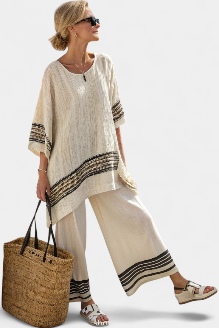 Beige two-piece set with black striped cuffs, loose tunic top and wide pants