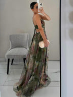 Maxi A-line dress with green painted floral print, side view and draped skirt