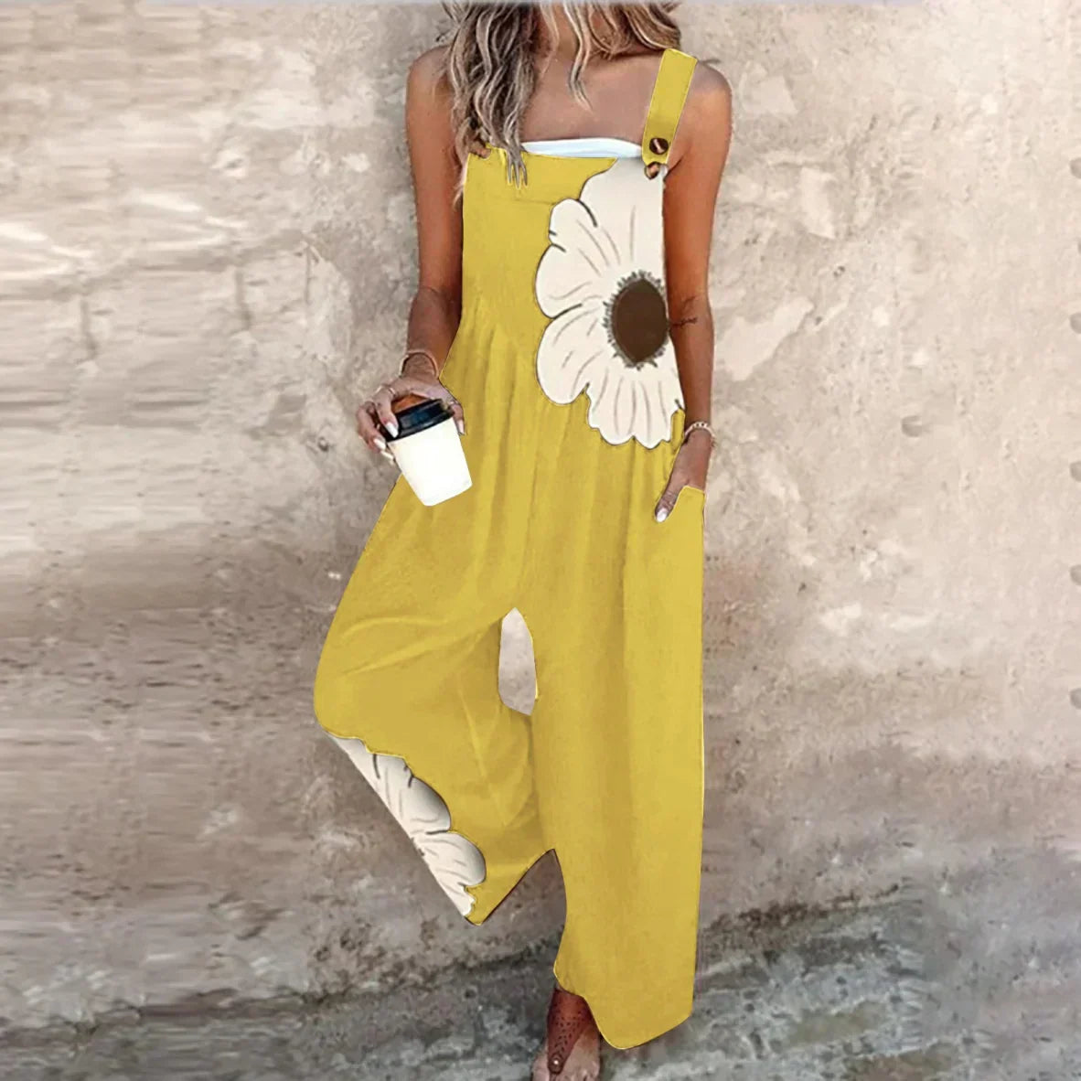 Yellow sleeveless jumpsuit with big white daisy print and wide-leg silhouette