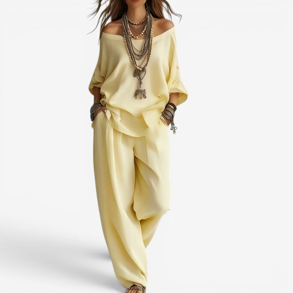 Yellow off-shoulder blouse and draped pants set, layered necklace detail