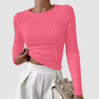Pink ribbed knit long-sleeve top with round neck and draped asymmetrical hem