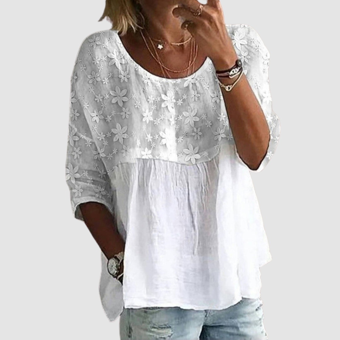 White loose-fit shirt with floral embroidery, gathered yoke, and three-quarter sleeves