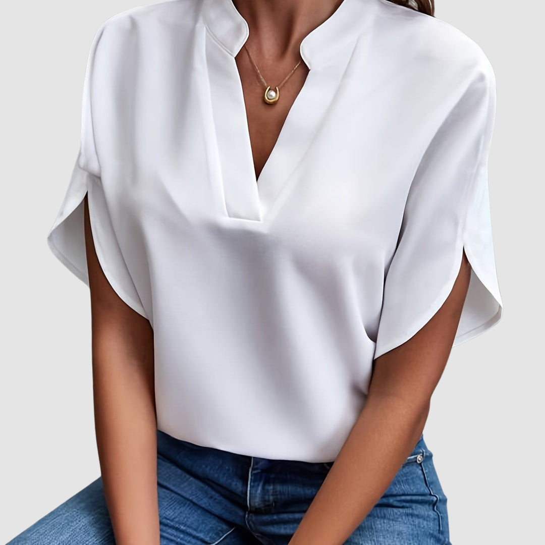 White draped blouse with V-neck and short dolman sleeves, loose side drape