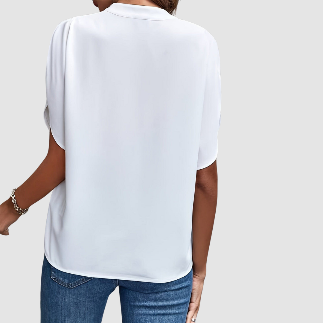 White draped blouse back view with short dolman sleeves and flowing drape