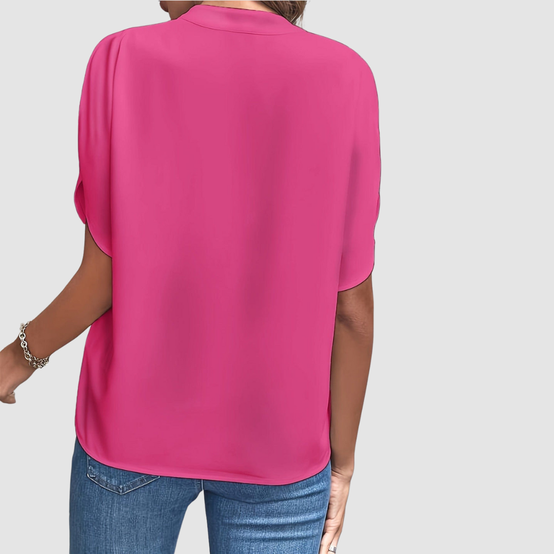 Pink draped blouse back view with short dolman sleeves and flowing drape