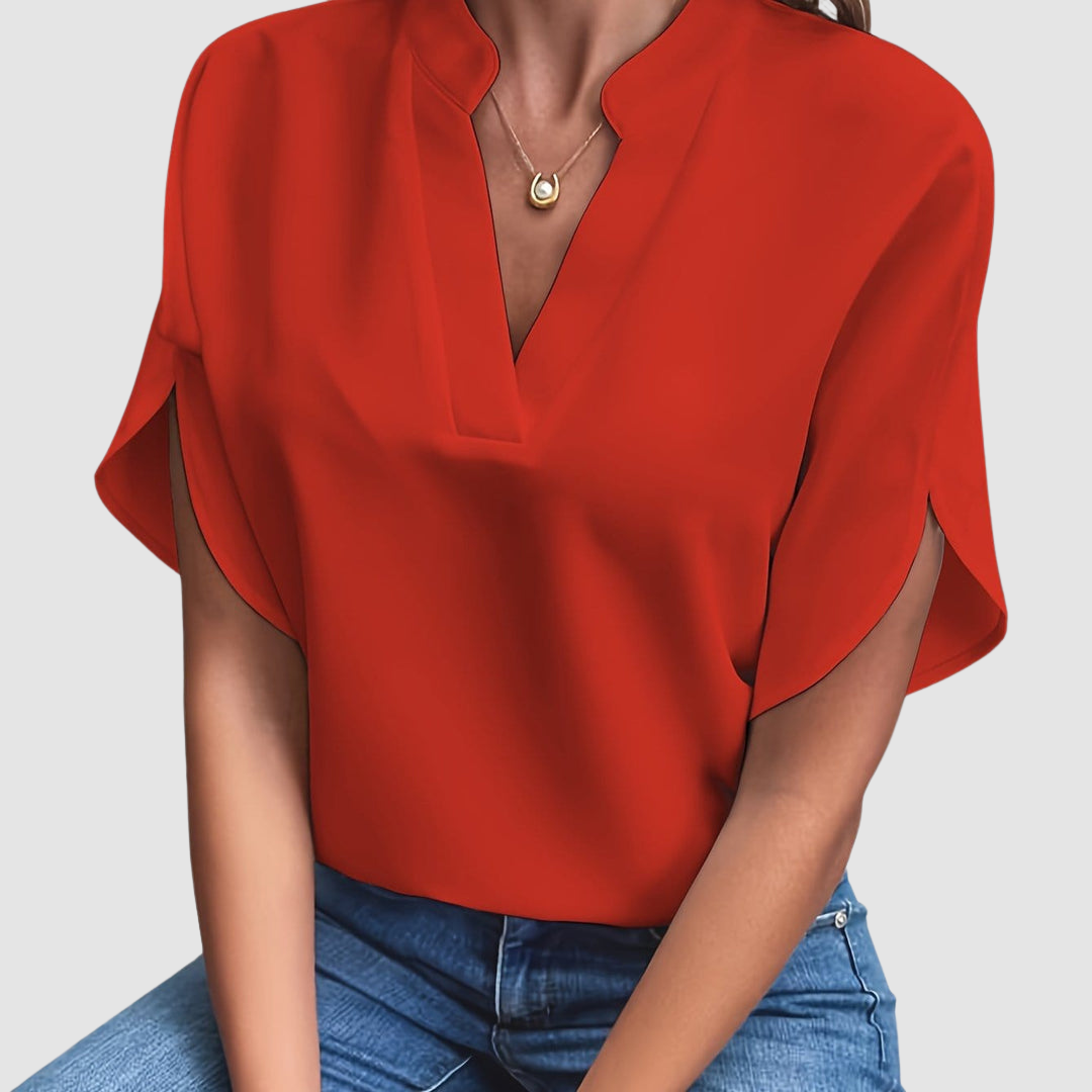 Red draped blouse with V-neck and short dolman sleeves, loose side drape