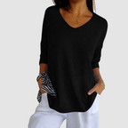 Black knit v-neck top with three-quarter sleeves and relaxed drape.