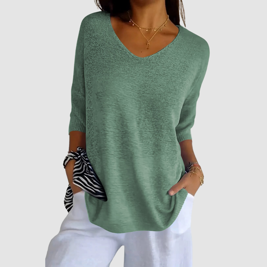 Light green knit v-neck top with three-quarter sleeves and loose draped fit.