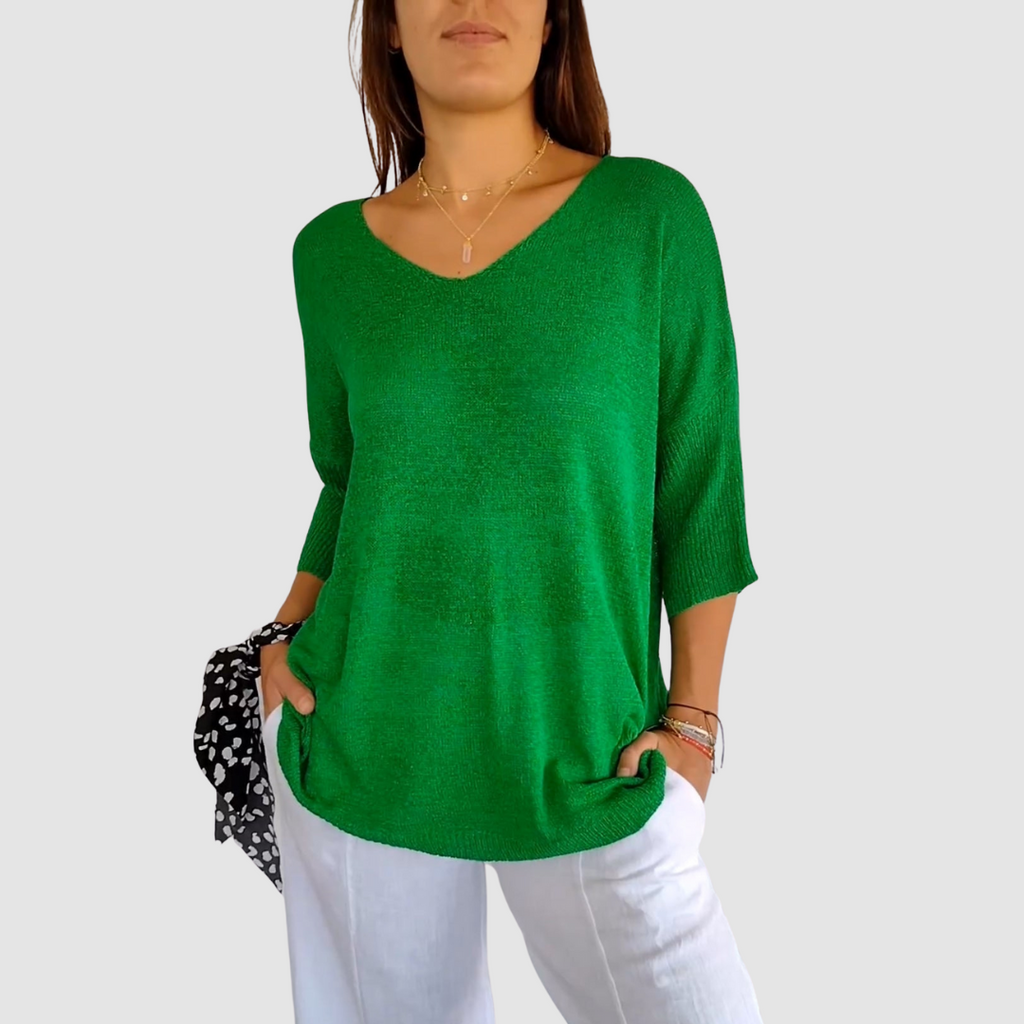 Green knit v-neck top with three-quarter sleeves and loose relaxed fit.