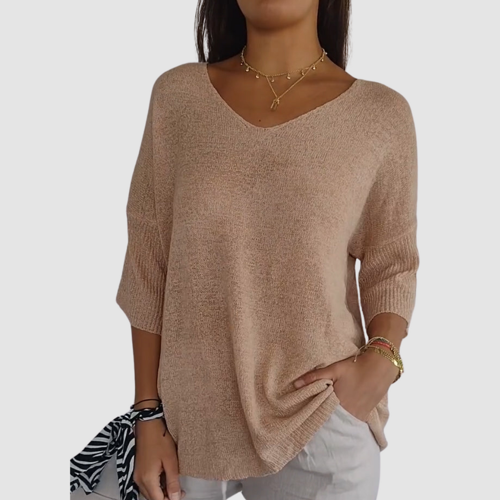 Apricot knit v-neck top with three-quarter sleeves and loose drape fit.