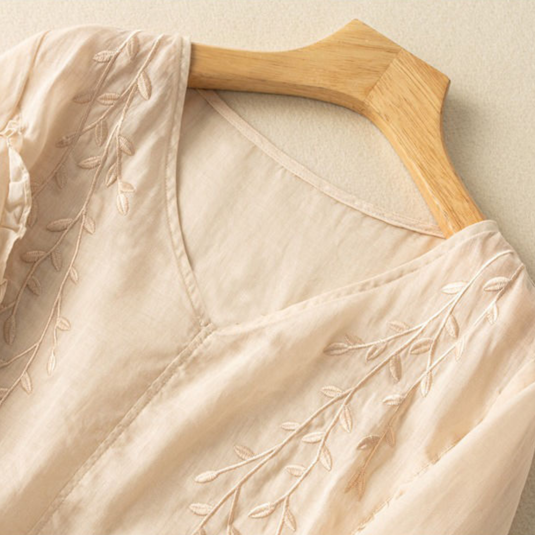 Cream cotton-linen V-neck top with leaf embroidery along neckline