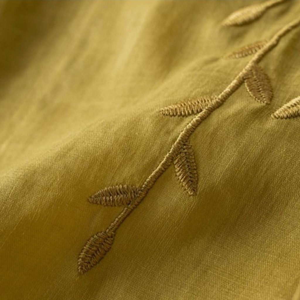Yellow cotton-linen fabric with stitched leaf embroidery