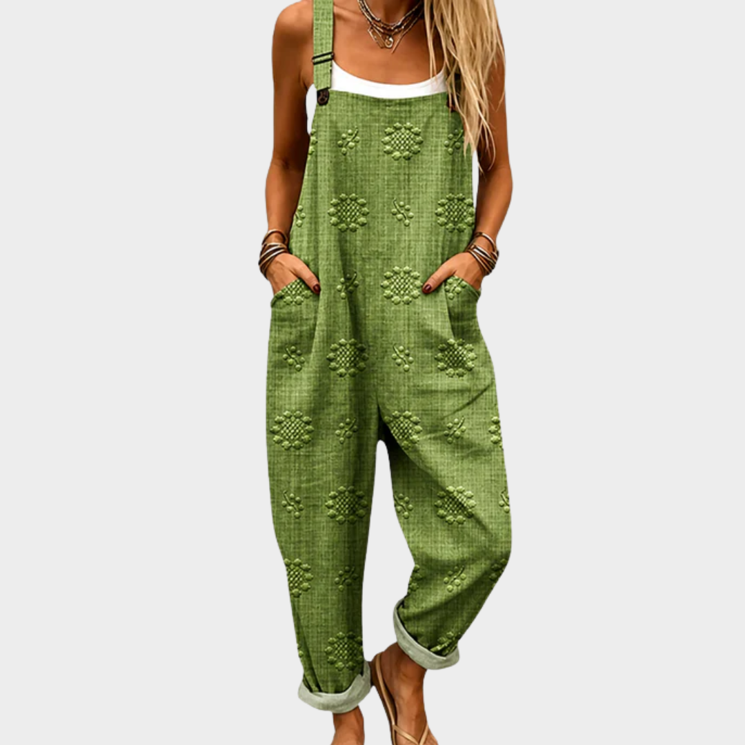 Green printed jumpsuit with small medallion pattern, sleeveless straps and loose wide legs