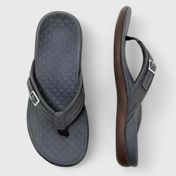 Black orthopedic sandals with textured footbed and adjustable ankle strap