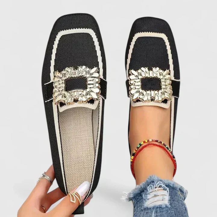 Comfort support loafer in black with white stripe and gold jeweled strap detail
