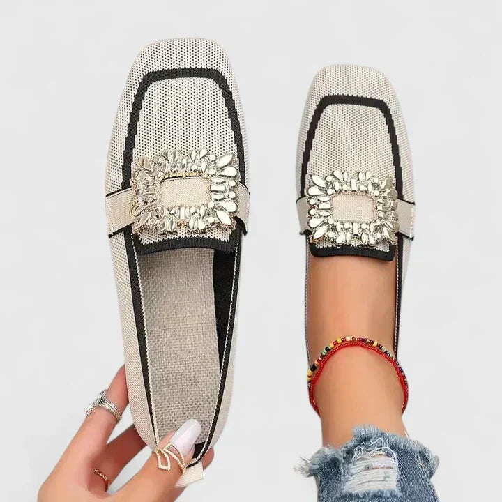 Comfort support loafer in cream with black stripe and gold jeweled strap detail