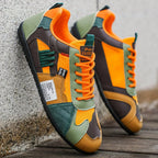 Colorful retro sneakers close-up: orange laces with green, brown and teal trim