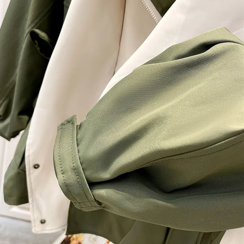 Windbreaker sleeve cuff detail with olive outer and off-white inner panel