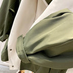 Windbreaker sleeve cuff detail with olive outer and off-white inner panel