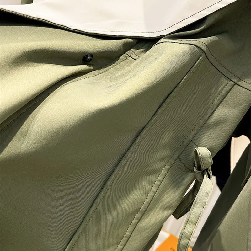 Olive green windbreaker jacket front with button placket and drawstring hood opening