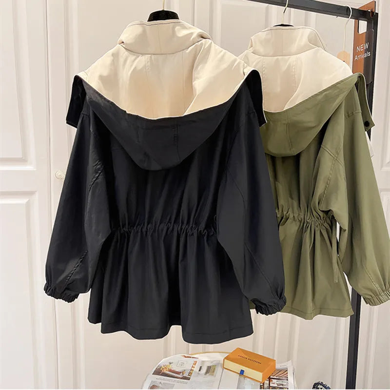 Hooded windbreaker jackets in black and olive green hanging side by side