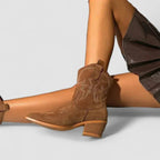 Brown suede western boots with pointed toe, stacked heel, and side pull-on panel