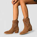 Brown western mid-heel boots with pull-on tab and decorative stitched emblem